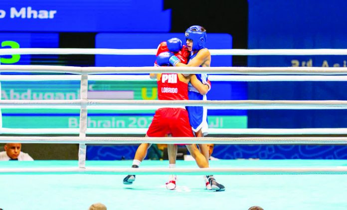 sports_Peralta_resized_compressed Negrense boxer Leo Mhar Lobrido trades blows with Uzbekistan’s Abdugani Yorkinjonov in their Boys’ 46-kg semifinal bout. POC PHOTO