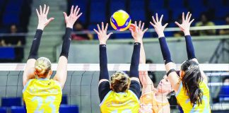 Farm Fresh Foxies import Helene Rosseaux scores through the defense of three Capital1 Solar Spikers during their PVL Reinforced Conference match at the Smart Araneta Coliseum.