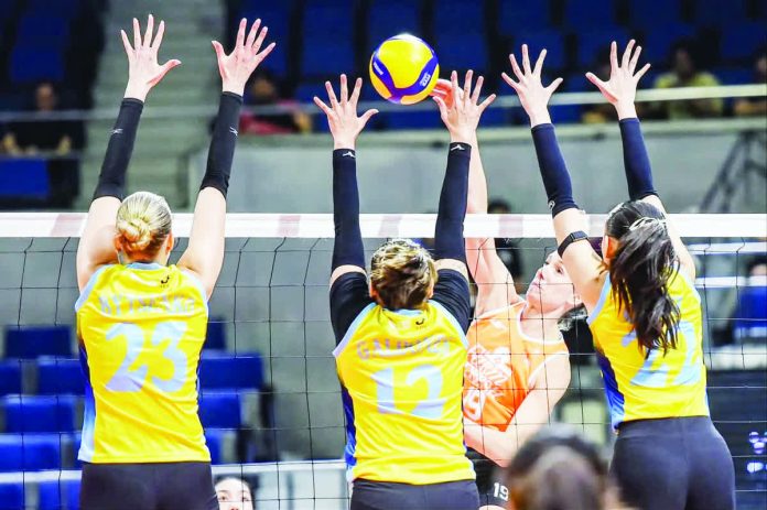 Farm Fresh Foxies import Helene Rosseaux scores through the defense of three Capital1 Solar Spikers during their PVL Reinforced Conference match at the Smart Araneta Coliseum.