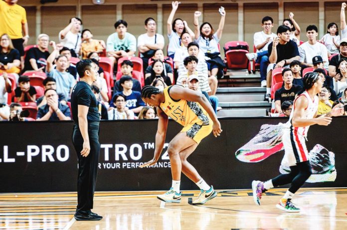 sports_UST_resized University of Santo Tomas Growling Tigers' Collins Akowe gestures after scoring against University of the East Red Warriors. UAAP PHOTO