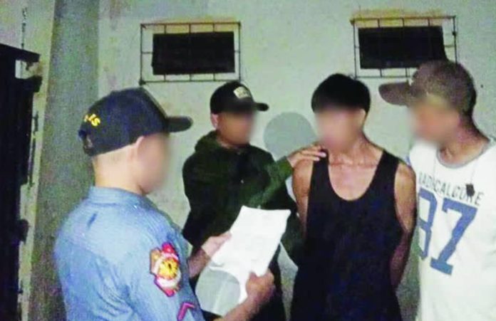 wanted Police officers from the Police Regional Office 6 serve a warrant of arrest to a wanted person during a night operation as part of the region’s intensified manhunt drive. PRO-6 PHOTO