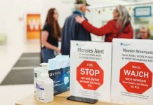Canada loses its measles-free status, with US on track to follow People stand near healthy awareness posters related to the measles outbreak during a public health awareness campaign, at the Taber Health Centre, in the largely Mennonite community of Taber, Alberta, Canada. GETTY IMAGES