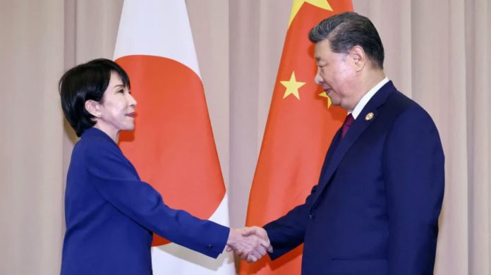 China_compressed_compressed_compressed Japanese prime minister Sanae Takaichi (left) shakes hands with Chinese President Xi Jinping in front of the Japanese and Chinese flags in South Korea on October 31. KYODO VIA REUTERS