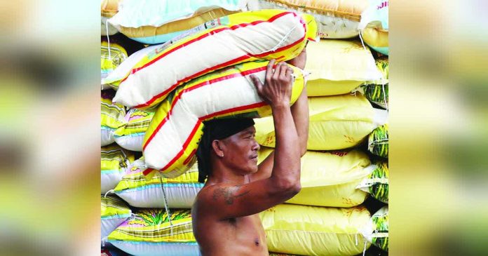 DA rice copy_superimposed_compressed A worker loads sack of rice on Dagupan Street in Manila. The country’s rice stocks totaled 2.35 million metric tons as of Oct. 1, up 3.2 percent from the same month last year, data from the Philippine Statistics Authority showed. INQUIRER PHOTO / NINO JESUS ORBETA
