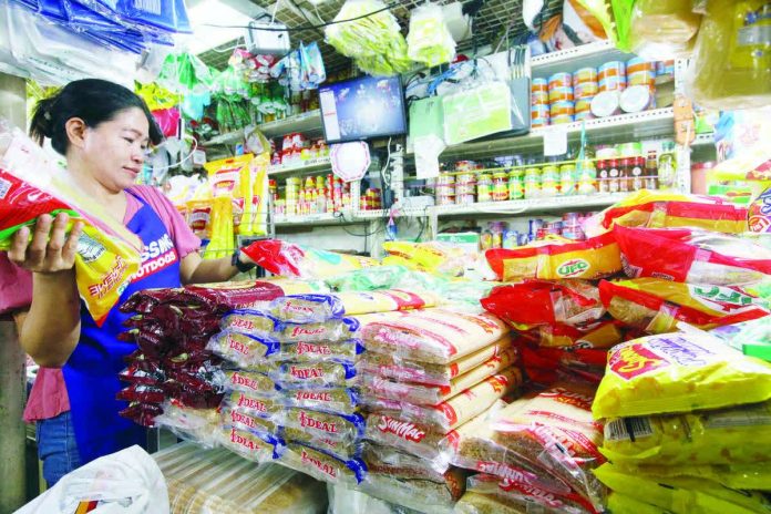 A store owner arranges noche buena food items at her stall at the Paco Public Market in Manila. The Department of Trade and Industry said prices of food products for noche buena have remained stable while others even decreased. PNA