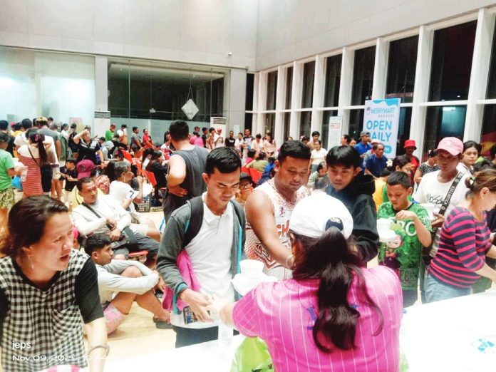Stranded Guimarasnon passengers and workers wait for assistance at Parola Wharf, Iloilo City, on the night of November 9, after sea travel was suspended due to Typhoon “Uwan.” The Provincial Government of Guimaras provided food packs and transport aid to affected individuals. PROVINCE OF GUIMARAS PHOTO