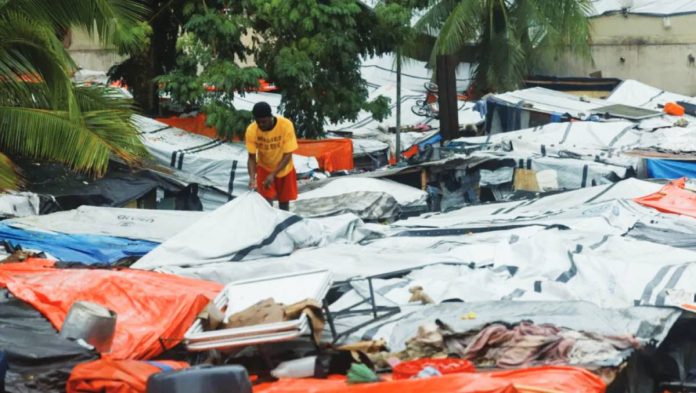 Haiti A man inspects plastic sheets serving as roofs for makeshift homes during heavy rains brought by Hurricane Melissa, at a Church of Jesus Christ of Latter-day Saints shelter, in Port-au-Prince, Haiti, on October 29, 2025. REUTERS