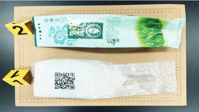 A wrapper of a Chinese oolong tea bag is laid along side a pack of ketamine. Some 28kg of ketamine, wrapped in foil and labelled with the Chinese character for tea, have been found in South Korea in the last two months. JEJU COAST GUARD
