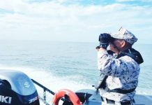 Dozens missing after migrant boat sinks near Malaysia-Thailand border A Malaysian Coast Guard official uses binoculars to search for survivors of a sunken boat. MALAYSIA COAST GUARD