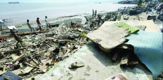 Residents check shoreline debris after Typhoon “Tino” caused devastation in Talisay City, Cebu province. The National Disaster Risk Reduction and Management Council reports massive casualties and agricultural devastation in the Visayas, particularly in Cebu. AP