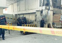 A part of the Federal Constabulary headquarters in Peshawar, Pakistan is cordoned off with yellow tape after a suicide bomb attack. Security officers armed with guns are seen on site. BBC