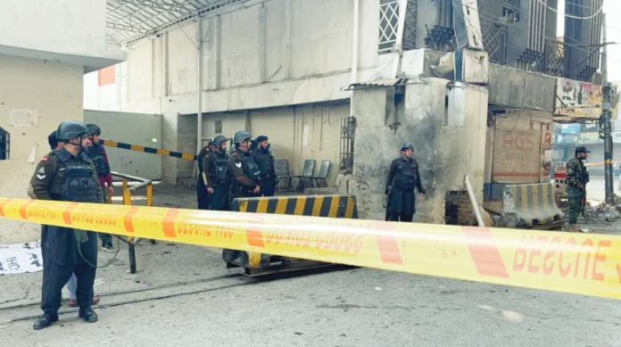Pakistan A part of the Federal Constabulary headquarters in Peshawar, Pakistan is cordoned off with yellow tape after a suicide bomb attack. Security officers armed with guns are seen on site. BBC