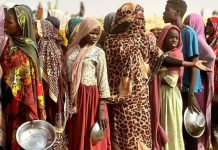 People who fled the Zamzam camp for the internally displaced after it fell under RSF control, queue for food rations in a makeshift encampment in an open field near the town of Tawila in war-torn Sudan's western Darfur region. AFP VIA GETTY IMAGES