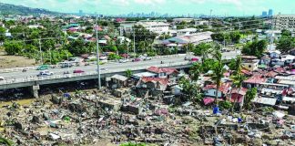 This aerial photo shows damaged houses in the aftermath of Typhoon Tino in Talisay, in Cebu province on November 5, 2025. AFP