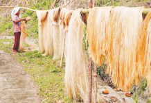 Cris Icawat hangs abaca fiber to dry along a highway in Barangay Sagrada, Bagamanoc, Catanduanes in this file photo. GEORGE CALVELO, ABS-CBN NEWS/FILE PHOTO