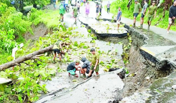 front pic_compressed All local governments in Western Visayas were ordered on Friday, Nov. 7, to implement preemptive evacuations in high-risk areas in preparation for Severe Tropical Storm “Uwan,” which is expected to enter the Philippine Area of Responsibility on Nov. 8. Photo shows a portion of the road in Lopez Vito, San Joaquin, Iloilo damaged by continuous rains brought by Typhoon “Tino. LEDIMAY SANSAET PHOTO