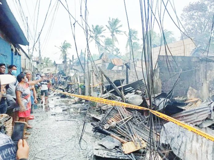 mai Oton blaze copy Residents survey the aftermath of a fire that gutted several houses in Barangay Poblacion South, Oton, Iloilo on Sunday morning, November 9, 2025, leaving 13 families homeless. Fire officials said narrow pathways and strong winds hampered firefighting efforts. GMA SUPER RADYO ILOILO PHOTO