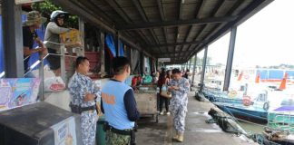 Philippine Coast Guard personnel and police officers inspect the Iloilo-Guimaras wharf as sea trips are suspended across Western Visayas due to Super Typhoon “Uwan.” AJ PALCULLO/PN