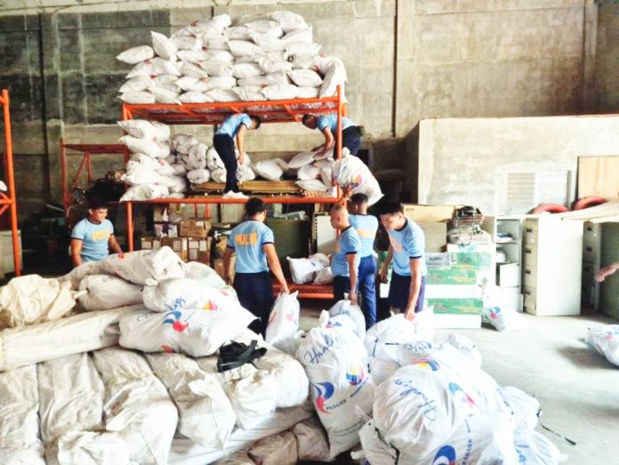 neljoy relief copy Volunteer police personnel assist the Office of Civil Defense - Region 6 in packing and dispatching relief goods and rice supplies for communities hit hard by typhoons “Ramil”, “Tino” and “Uwan” across Western Visayas these past two months. OCD-6 PHOTO
