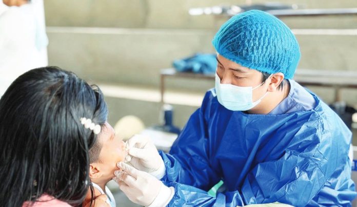A Department of Health dentist checks the teeth of a boy. The department promotes preventive dental care and good oral hygiene among Filipinos. DOH-6 PHOTO