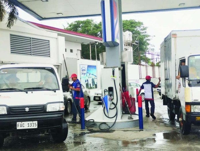 oil_price_hikes_resized_compressed Gasoline station workers attend to clients in Barangay Mali-ao, Pavia, Iloilo, on Monday, Nov. 24, 2025. Gasoline and diesel prices are going up this week. PN PHOTO