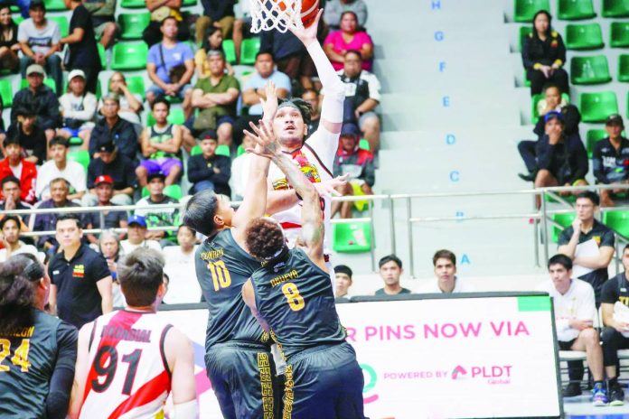 sports San Mig copy_compressed San Miguel Beermen center June Mar Fajardo rises for a one-hander against Titan Ultra’s interior defense during their explosive 158-point win. PBA PHOTO