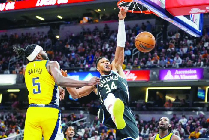 sports_Ante.JPG_resized_compressed Milwaukee Bucks’ Giannis Antetokounmpo soars for a dunk. AP