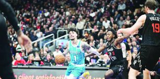 Charlotte Hornets' LaMelo Ball eludes the defense of Toronto Raptors guard Immnauel Quickley. PHOTO BY IMAGN IMAGES