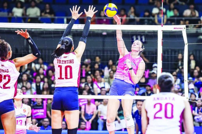 sports_Cool_resized_compressed Creamline Cool Smashers’ Courtney Schwan rises for a kill against the outstretched arms of Choco Mucho’s Kat Tolentino. PVL PHOTO