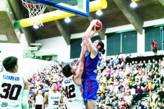 sports_Gilas_resized_compressed Gilas Pilipinas' Quentin Millora-Brown scores against the defense of Guam's Tai Wesley. FIBA PHOTO