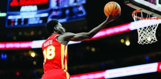 Atlanta Hawks center Mouhamed Gueye soars for a basket as Los Angeles Lakers' Luka Doncic looks on. AP