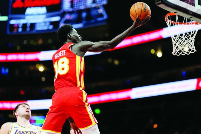sports_Gu.JPG_resized_compressed Atlanta Hawks center Mouhamed Gueye soars for a basket as Los Angeles Lakers' Luka Doncic looks on. AP