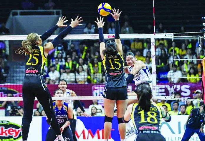 sports_NU_resized_compressed National University’s Sam Cantada rises for a kill against the University of Santo Tomas’ front line during Game 1 of the SSL Finals. SSL PHOTO