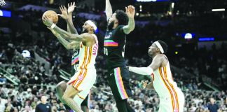 Atlanta Hawks guard Nickeil Alexander-Walker (7) drives to the basket past San Antonio Spurs forward Julian Champagnie (30). PHOTO COURTESY OF SCOTT WACHTER/IMAGN IMAGES