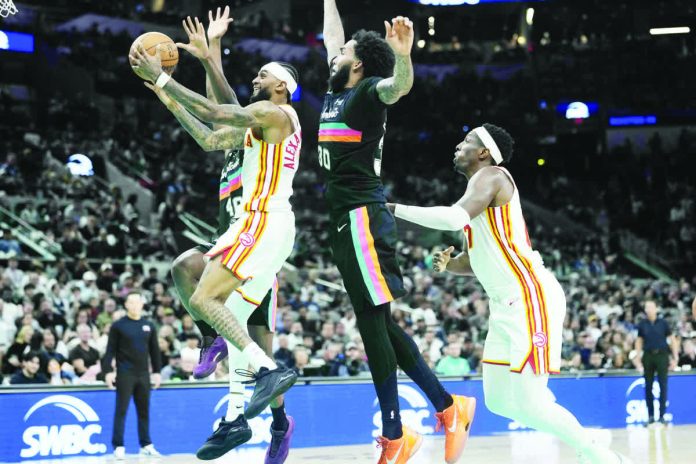 sports_San_Antonio_copy_resized_compressed Atlanta Hawks guard Nickeil Alexander-Walker (7) drives to the basket past San Antonio Spurs forward Julian Champagnie (30). PHOTO COURTESY OF SCOTT WACHTER/IMAGN IMAGES