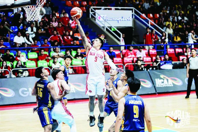 sports_San_Beda_resized_compressed Ilonggo guard John Bryan Sajonia of the San Beda Red Lions attacks the rim against the JRU Heavy Bombers’ defense. NCAA PHOTO