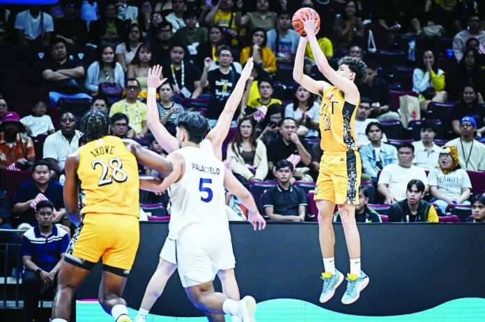 sports_UAAP_copy_resized_compressed University of Santo Tomas Growling Tigers forward Angelo Crisostomo pulls up for a three-point attempt. UAAP PHOTO