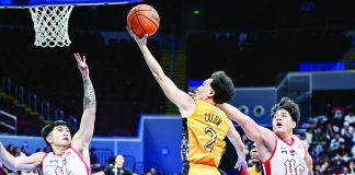 University of Santo Tomas’ Ivanne Calum stretches for a layup against UE’s defense during their UAAP Season 88 matchup. UAAP PHOTO