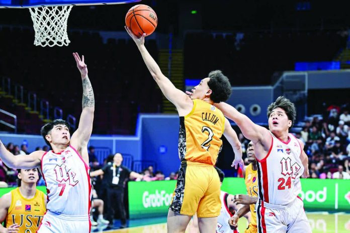 sports_UST_copy_resized_compressed University of Santo Tomas’ Ivanne Calum stretches for a layup against UE’s defense during their UAAP Season 88 matchup. UAAP PHOTO