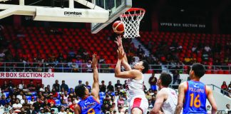 Barangay Ginebra’s Japeth Aguilar muscles his way to the basket against NLEX defenders during their PBA Philippine Cup clash. PBA PHOTO