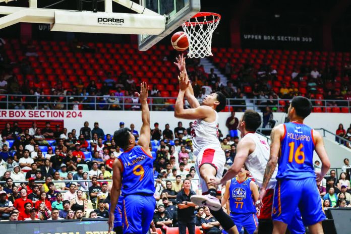 sports_Veteran_resized_compressed Barangay Ginebra’s Japeth Aguilar muscles his way to the basket against NLEX defenders during their PBA Philippine Cup clash. PBA PHOTO