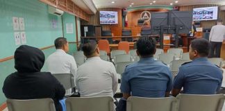 DPWH-Mimaropa Planning and Design head Montrexis Tamayo (in black) awaits as CIDG operatives prepare to present him at the Sandiganbayan on November 26. Photo courtesy of the PNP