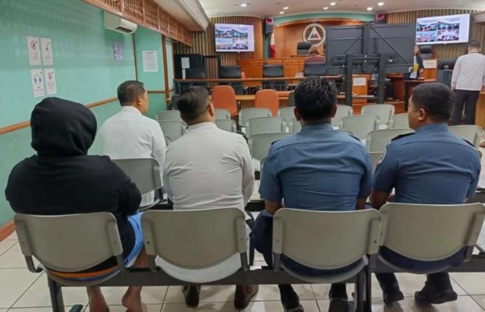 tamayo-sandiganbayan-pnp DPWH-Mimaropa Planning and Design head Montrexis Tamayo (in black) awaits as CIDG operatives prepare to present him at the Sandiganbayan on November 26. Photo courtesy of the PNP