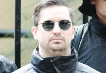 Matthew Gruter, seen among black-clad men at the protest, moved to Australia with his wife in 2022. The South African man has been taken into immigration detention after his visa was revoked. BBC