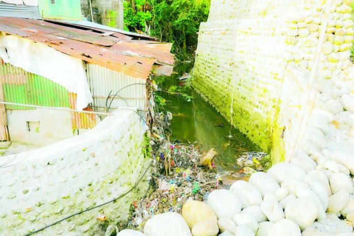 The illegal fencing in Sulom Creek, Barangay Villamonte, Bacolod City obstructs the flow of water, causing flooding and posing risks to residents living near the property. MAYOR GREG GASATAYA FB PHOTO