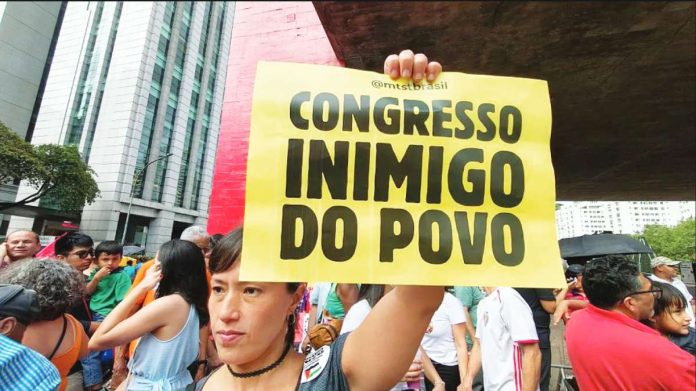 People gather during a demonstration to oppose the sentence-reduction bill, known as PL da Dosimetria, that could pave the way for former Brazilian President Jair Bolsonaro's amnesty, in Sao Paulo, Brazil, on December 14, 2025. Some protesters held up signs denouncing members of Congress as "enemies of the people." GETTY IMAGES