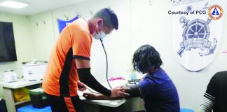 A Philippine Coast Guard personnel checks the vital signs of rescued fishermen who were water-cannoned by the China Coast Guard in Escoda Shoal in the West Philippine Sea on December 12, 2025. PHOTO FROM THE PHILIPPINE COAST GUARD
