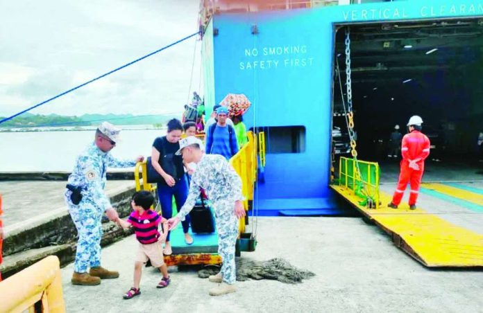 HOLIDAY WATCH AT THE PORTS. Philippine Coast Guard personnel assist and monitor passengers as holiday travelers disembark and queue at ports in Western Visayas, part of heightened security and safety measures being enforced amid the surge of sea travel ahead of Christmas and New Year. PCG Photo