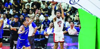 Barangay Ginebra San Miguel Kings' Stephen Holt drills a corner triple as Converge FiberXers' King Caralipio tries to give chase. PBA PHOTO