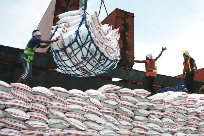 imported_rice_copy_resized Workers unload sacks of rice imported from Thailand at Harbor Center in Tondo, Manila. DANNY PATA/FILE PHOTO